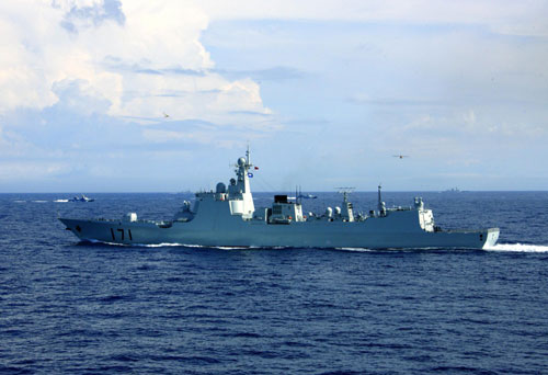 A warship moves during a live-ammunition military drill held by the South China Sea Fleet of the People's Liberation Army (PLA) Navy in the South China Sea, Hainan province, July 26, 2010.[Photo/Xinhua] 