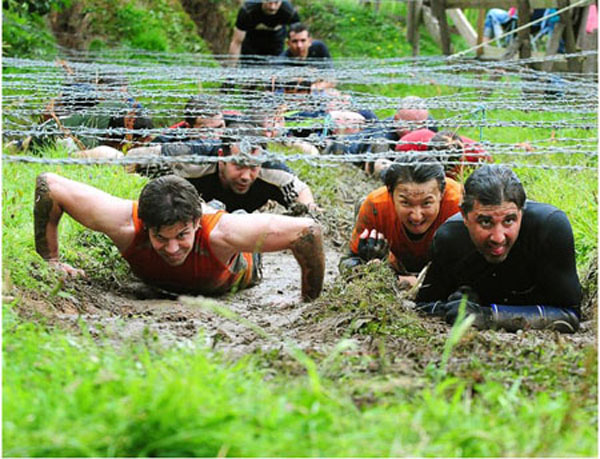 Competitors crawl on their bellies through icy mud beneath barbed wire in Wolverhampton, England on July 25, 2010. Thousands run the biannual assault course, and are challenged by 21 different obstacles, including, fire, tunnels, and swamps to complete the track.