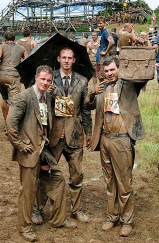 Several Tough Guy racers smile during the Tough Guy Challenge, at South Perton Farm, in Wolverhampton, England, July 25, 2010.