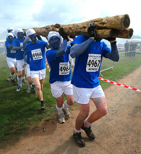 Several Tough Guy racers smile during the Tough Guy Challenge, at South Perton Farm, in Wolverhampton, England, July 25, 2010.