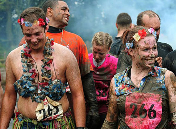 Several Tough Guy racers smile during the Tough Guy Challenge, at South Perton Farm, in Wolverhampton, England, July 25, 2010.