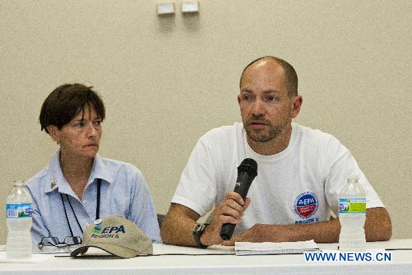 U.S. Environmental Protection Agency (EPA) Regional Director Susan Hedman (L) and her colleague, deputy official Mark Durno, answer questions at a news conference in Marshall, Michigan, the United States, July 31, 2010.