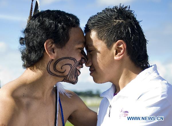 LAN SIALII (R), a Maori culture performer, attends a local Maori welcoming ceremony during the flame arrival ceremony at the airport in Auckland, New Zealand, July 31, 2010.The torch for the Singapore 2010 Youth Olympic Games journey arrived in Auckland on Saturday.