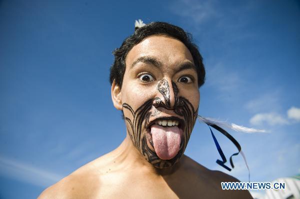 A dancer shows the Maori cultural performance during the flame arrival ceremony at the airport in Auckland, New Zealand, July 31, 2010. The torch for the Singapore 2010 Youth Olympic Games journey arrived in Auckland on Saturday.