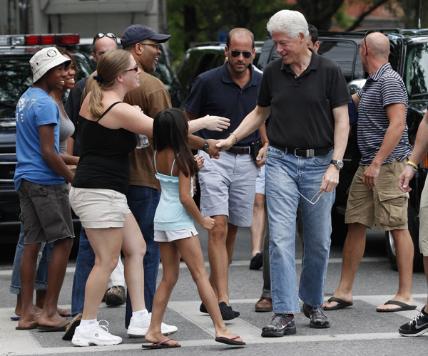 Former U.S. president Bill Clinton greets supporters as he gets out of a vehicle in Rhinebeck, New York July 30, 2010.