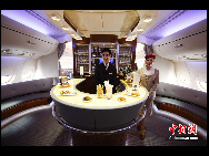 Flight attendants pose in the bar connecting the first class and business class of Emirates' Airbus A380 which arrives at the Capital International Airport in Beijing August 1, 2010.[Chinanews.com]