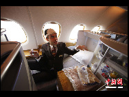 A steward gestures as he shows the interior design in business class of the Emirates Airlines' A380 passenger plane which arrives at the Capital International Airport in Beijing August 1, 2010.[Chinanews.com]