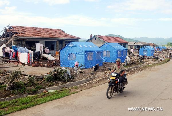 Photo taken on Aug. 1, 2010 shows makeshift tents in Huadian, northeast China&apos;s Jilin Province. Rain-triggered flood swept several townships in Huadian City since July 27. Measures have been taken to carry on post-disaster reconstruction. [Xinhua]