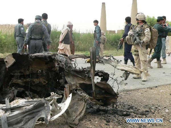 Police check the blast site in Kandahar, south Afghanistan, Aug. 2, 2010. A suicide car bombing targeted a local official of Afghanistan&apos;s southern Kandahar province killed four civilians including two children Monday morning. [Zalmay/Xinhua]