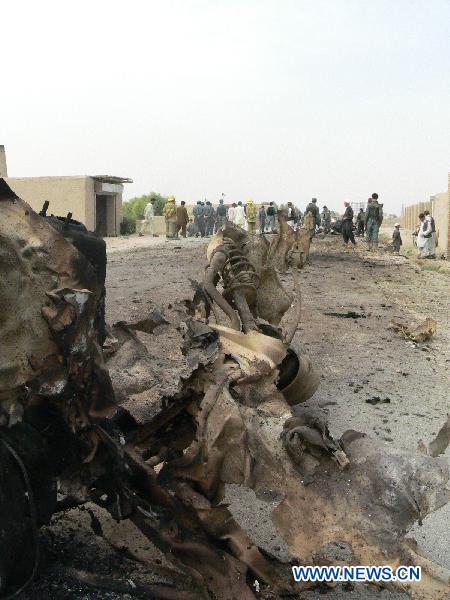 People stand at the blast site in Kandahar, south Afghanistan, Aug. 2, 2010.[Zalmay/Xinhua]