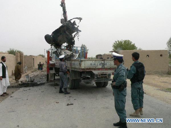 Police clean the blast site in Kandahar, south Afghanistan, Aug. 2, 2010. [Zalmay/Xinhua]