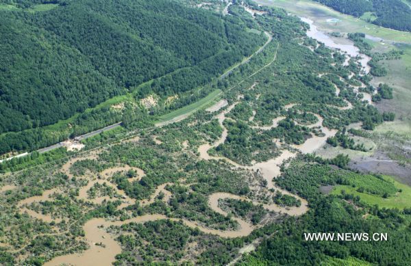 The aerial photo taken on July 30, 2010 shows the flood-battered area in Antu County of Yanbian Korean Autonomous Prefecture, northeast China's Jilin Province. [Xinhua] 