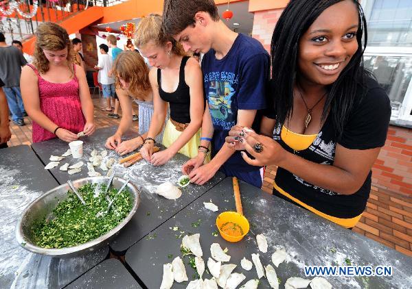 American high school students make dumplings in Nanjing, capital of Jiangsu Province, Aug. 3, 2010. [Sun Can/Xinhua]
