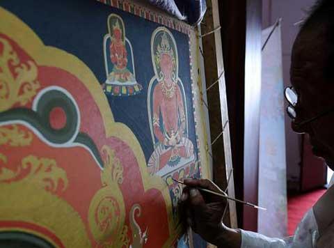 Thangka is a Tibetan silk painting with embroidery, usually depicting a Buddhist deity, famous scene, or mandala of some sort.