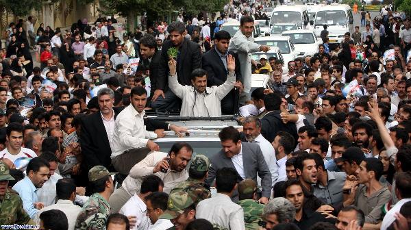 Iranian President Mahmoud Ahmadinejad (C) waves to people as he is welcomed to Hamadan, 336 kilometres (209 miles southwest of Tehran, August 4, 2010. [Xinhua]