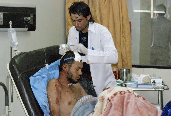 A wounded resident is treated at a hospital after a bomb attack in Kut, 150 km (95 miles) southeast of Baghdad, August 4, 2010. Two bombs exploded in the usually quiet southern city of Kut in Iraq&apos;s Wasit province on Tuesday.[Xinhua]