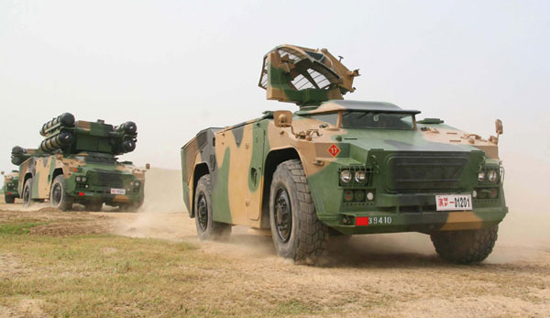 An armored vehicle moves into the field during the five-day military exercise code-named 'Vanguard-2010,' across Henan and Shandong provinces, August 4, 2010. [Photo/Xinhua]