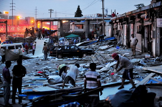 Residents repair their homes and stores destroyed in a powerful explosion at a plastics factory in Nanjing on July 28. 