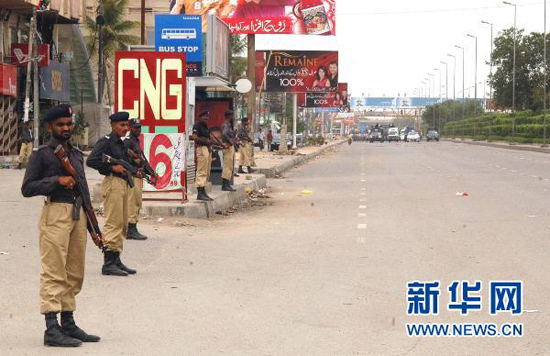Policemen are on duty on the street of Karachi, Pakistan, on August 4. Life is yet to get back to normal on Wednesday after 63 people have died in the past 48 hours in continuing violence following Monday's assassination of a politician.
