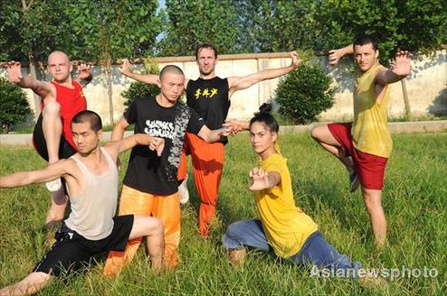 Overseas university students learn Shaolin kung fu at a kung fu school on Songshan Mountain of Central China's Henan province on August 4, 2010. More kung fu enthusiasts have come to China to learn Shaolin kung fu since the Shaolin Temple was added to the UNESCO World Heritage List on August 1, 2010. 