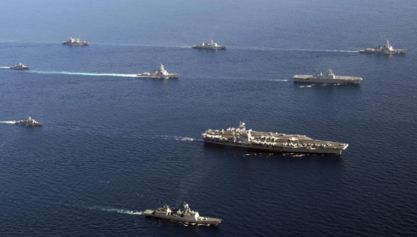 The US nuclear-powered aircraft carrier USS George Washington (3rd R) leads South Korean and US naval ships in formation during the US-South Korea joint naval and air exercise in the open seas east of South Korea, July 26, 2010. [Agencies] 