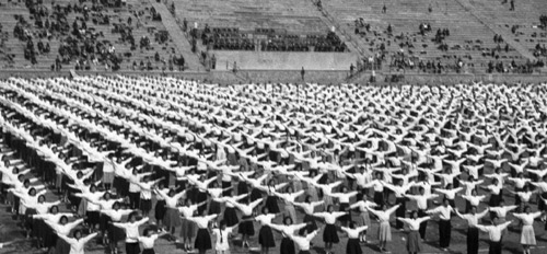 Staff workers perform radio gymnastic exercises at a sports meeting for workers in East China&apos;s Jiangsu province in this file photo taken on May 12, 1956. [Xinhua] 