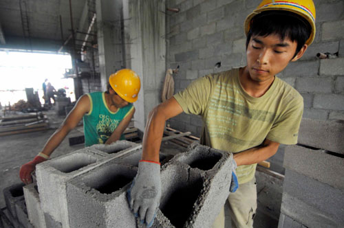 Students carry air bricks at North University of Nationalities in Yinchuan, Northwest China&apos;s Ningxia Hui autonomous region, Aug 9, 2010. 