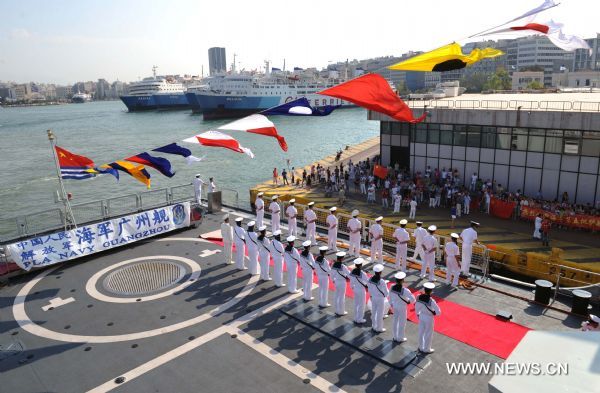 Chinese navy soldiers wave upon their arrival at Pireaus Port of Greece, Aug. 9, 2010. Two Chinese naval warships destroyer Guangzhou and frigate Chaohu, which are part of the fifth Chinese naval escort flotilla, arrived on Monday at Pireaus Port for a visit to Greece. [Liu Chunhui/Xinhua]