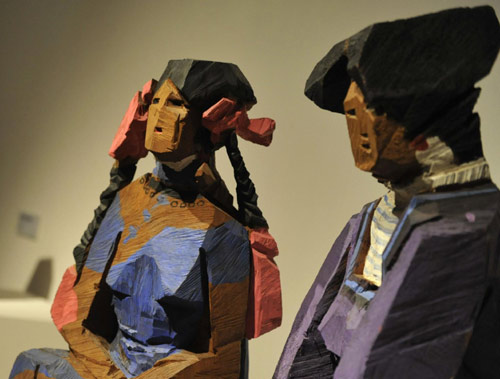 Wooden sculptures with colorful painting of Taiwan artist Zhu Ming are on display during an exhibition at the National Art Museum of China in Beijing, August 8, 2010. [Xinhua] 