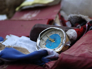 A broken clock lies in the ruins, Aug 9, 2010. Ordinary things are surfacing as the search and recue work continues in mudslide-hit Zhouqu county, Northwest China's Gansu province. About 45,000 residents have been evacuated, as mudslides destroyed more than 300 homes and damaged another 700. Also, 3,000 homes have been flooded. [Xinhua]