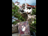 A wedding album lies in the ruins, Aug 10, 2010.  [Xinhua]