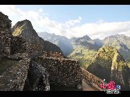 Machu Picchu is situated on a mountain ridge above the Urubamba Valley in Peru, which is 80 kilometres (50 mi) northwest of Cuzco and through which the Urubamba River flows. Most archaeologists believe that Machu Picchu was built as an estate for the Inca emperor Pachacuti (1438–1472). Often referred to as 'The Lost City of the Incas', it is perhaps the most familiar icon of the Inca World. [Photo by Xiaoyong]