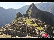 Machu Picchu is situated on a mountain ridge above the Urubamba Valley in Peru, which is 80 kilometres (50 mi) northwest of Cuzco and through which the Urubamba River flows. Most archaeologists believe that Machu Picchu was built as an estate for the Inca emperor Pachacuti (1438–1472). Often referred to as 'The Lost City of the Incas', it is perhaps the most familiar icon of the Inca World. [Photo by Xiaoyong]