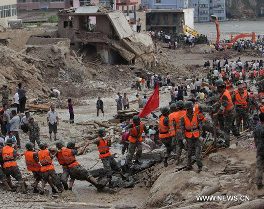 Rescuers work in the landslide-hit Zhouqu County, Gannan Tibetan Autonomous Prefecture in northwest China's Gansu Province, Aug. 9, 2010. The death toll from rain-triggered mudslides in Zhouqu County has risen to 702 as of Tuesday afternoon, with 1,042 others still missing. [Xinhua] 