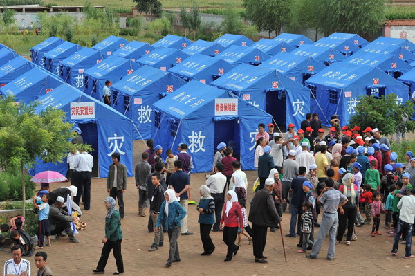 Makeshift tents are set up on the school playground for flood-affected residents in Tongxin county of Wuzhong city in Ningxia Hui autonomous region August 11, 2010. [Xinhua]