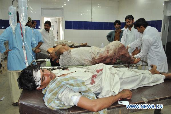 Injured men are treated at a local hospital in southwest Pakistan&apos;s Quetta on Aug. 11, 2010. At least two people were killed and four others were injured during a shootout by unidentified gunmen in Quetta. [Hassan/Xinhua]