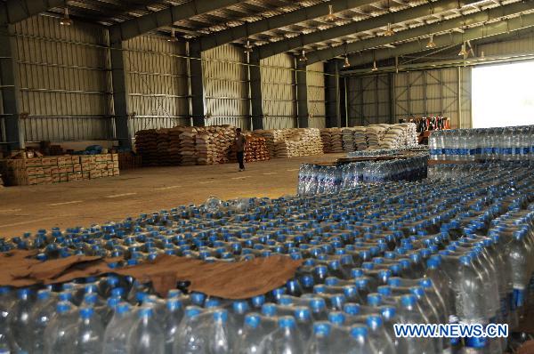 A staff checks the relief goods stored at an air base 100 kilometers northwest of Islamabad, Pakistan, Aug. 10, 2010. [Yan Zhonghua/Xinhua]