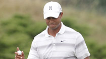 Tiger Woods of the U.S. waves after sinking a putt on the 15th green during a practice round for the 92nd PGA Golf Championship at Whistling Straits, in Kohler, Wisconsin, August 11, 2010.