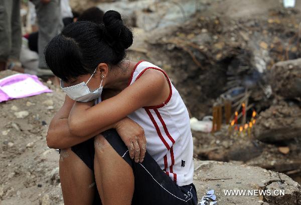 A resident cries for her relative killed by landslide in Zhouqu County, Gannan Tibetan Autonomous Prefecture in northwest China&apos;s Gansu Province, Aug. 12, 2010.[Xinhua] 
