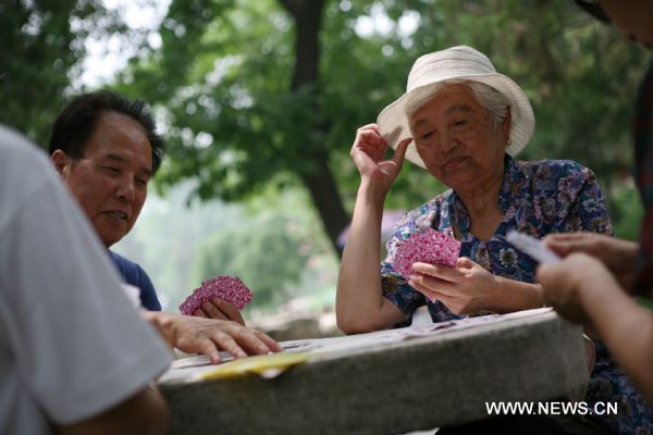 Elderly people play poker at a park in Beijing, capital of China, Aug. 12, 2010. China has 169 million citizens aged over 60, accounting for 12.5 percent of its total population. The figure would climb up to 31 percent by 2050, said Li Baoku, president of China Aging Development Foundation (CADF), on Wednesday.