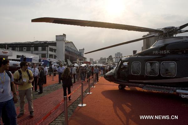 People visit the 2010 Latin American business aviation exhibition in Sao Paulo, Brazil, on Aug. 13, 2010. A total of 120 exhibitors displayed 55 aircraft in the event.