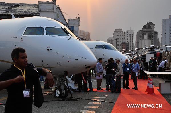 People visit the 2010 Latin American business aviation exhibition in Sao Paulo, Brazil, on Aug. 13, 2010. A total of 120 exhibitors displayed 55 aircraft in the event.