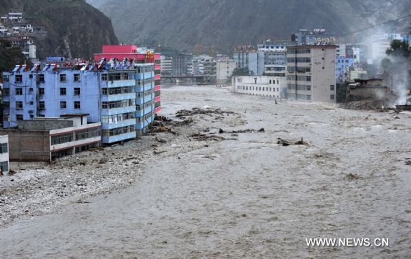 Photo taken on Aug. 13, 2010 shows the scene of Bailong River running through the landslide-hit Zhouqu County, Gannan Tibetan Autonomous Prefecture in northwest China's Gansu Province. Over 80 multi-storeyed buildings are still in seriously ponding area, with water depth of 3-5 meters at present.