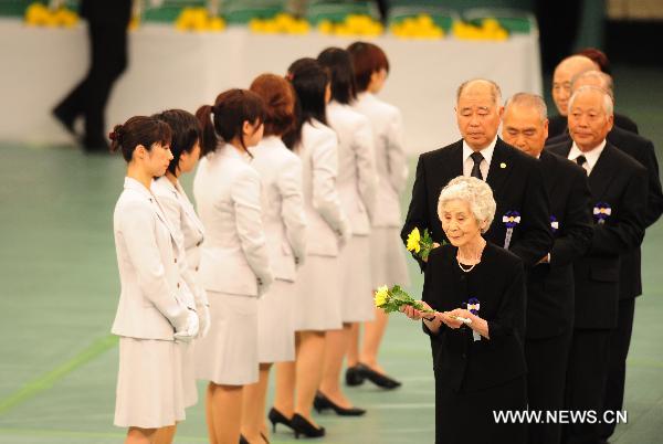 Representatives of the relatives of those died in World War Two walk to place flowers before an alter in a memorial service for those who died in World War Two during a ceremony marking the 65th anniversary of Japan&apos;s surrender in the war, in Tokyo Aug. 15, 2010. [Xinhua]