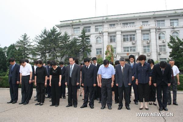 Staff members of the Chinese Embassy to the Democratic People's Republic of Korea (DPRK) pay a silent tribute to the victims of the Aug. 8 mudslide disaster in Zhouqu County, Gannan Tibetan Autonomous Prefecture in northwest China's Gansu Province, in Pyongyang Aug. 15, 2010. China on Sunday held mounrings for the mudslide victims, all over the country and at overseas embassies and consulates. 