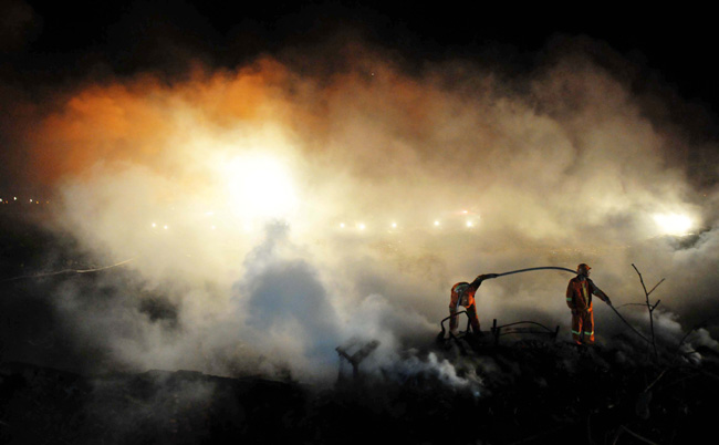 Firemen and rescuers work on the site of a fireworks factory explosion in Yichun of Northeast China&apos;s Heilongjiang province late into the night on August 16, 2010. [Xinhua] 