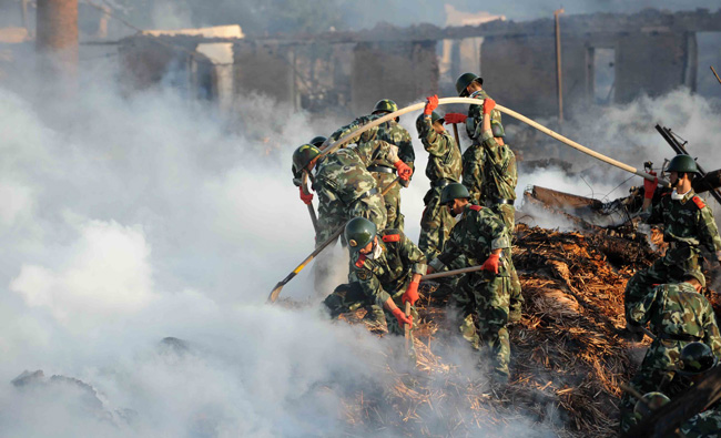 Firemen and rescuers work on the site of a fireworks factory explosion in Yichun of Northeast China&apos;s Heilongjiang province late into the night on August 16, 2010. [Xinhua]