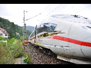 The destroyed and derailed Frankfurt-Paris InterCityExpress (ICE) highspeed train of German railway operator Deutsche Bahn AG is seen after a crash with a garbage truck in Lindenberg near Neustadt an der Weinstrasse, August 17, 2010. Nine passengers were left slightly hurt, one passenger remains seriously injured, and the truck driver escaped unharmed, police said.