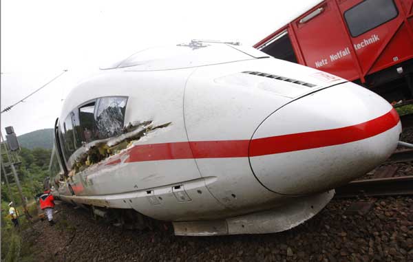 The destroyed and derailed Frankfurt-Paris InterCityExpress (ICE) highspeed train of German railway operator Deutsche Bahn AG is seen after a crash with a garbage truck in Lindenberg near Neustadt an der Weinstrasse, August 17, 2010. Nine passengers were left slightly hurt, one passenger remains seriously injured, and the truck driver escaped unharmed, police said. [Xinhua/Reuters] 