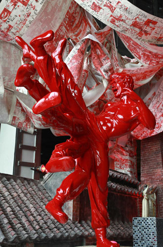 A red ceramic statue depicts an eight-legged Bruce Lee, known as Li Xiaolong in Chinese, at Foshan case pavilion inside Expo Park, Aug 17, 2010. [Xinhua] 